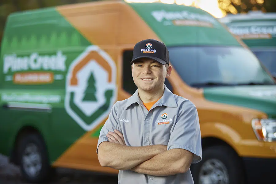 Pine Creek Plumber smiling in front of truck