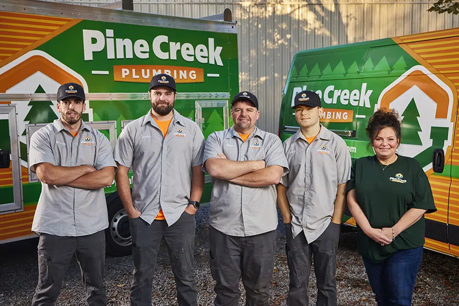 Pine Creek plumbing team with trucks in background