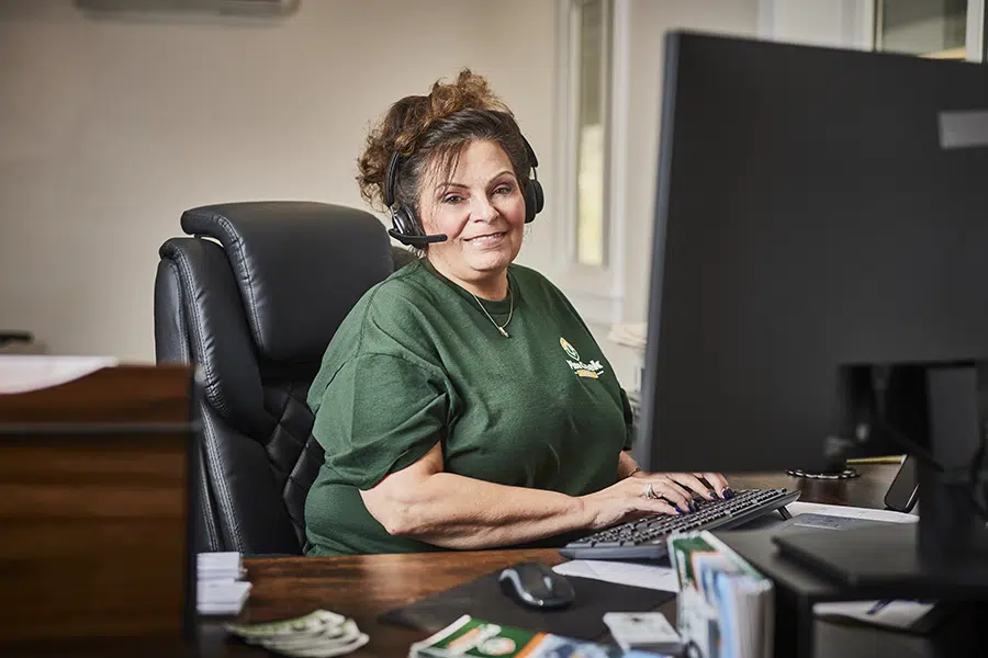 Pine Creek Plumbing office worker smiling and answering calls