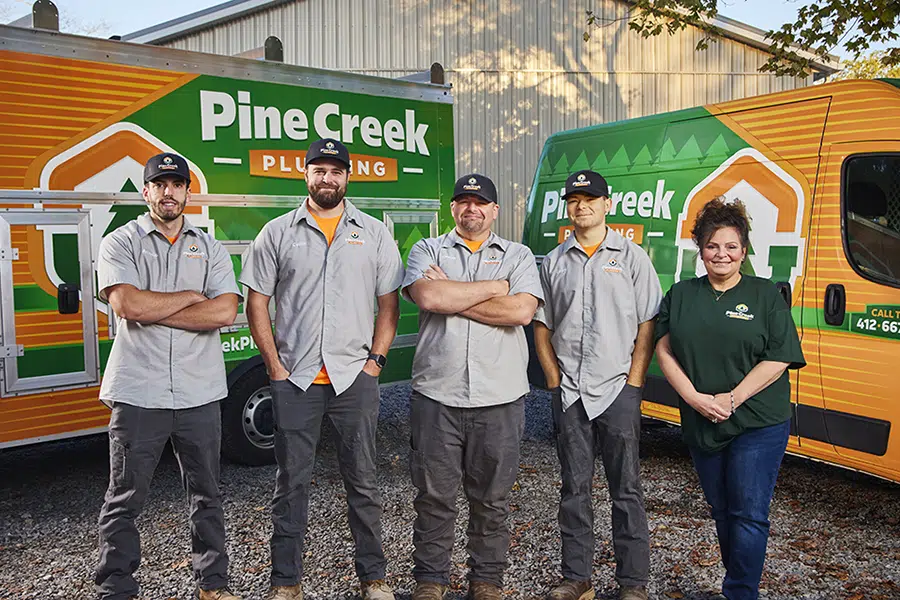 Pine Creek plumbing team with trucks in background