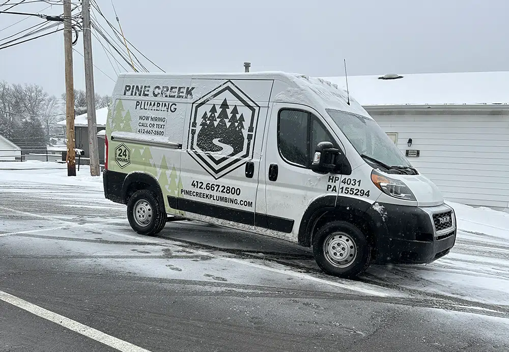 Pine Creek Plumbing truck parked with snow in Wexford.