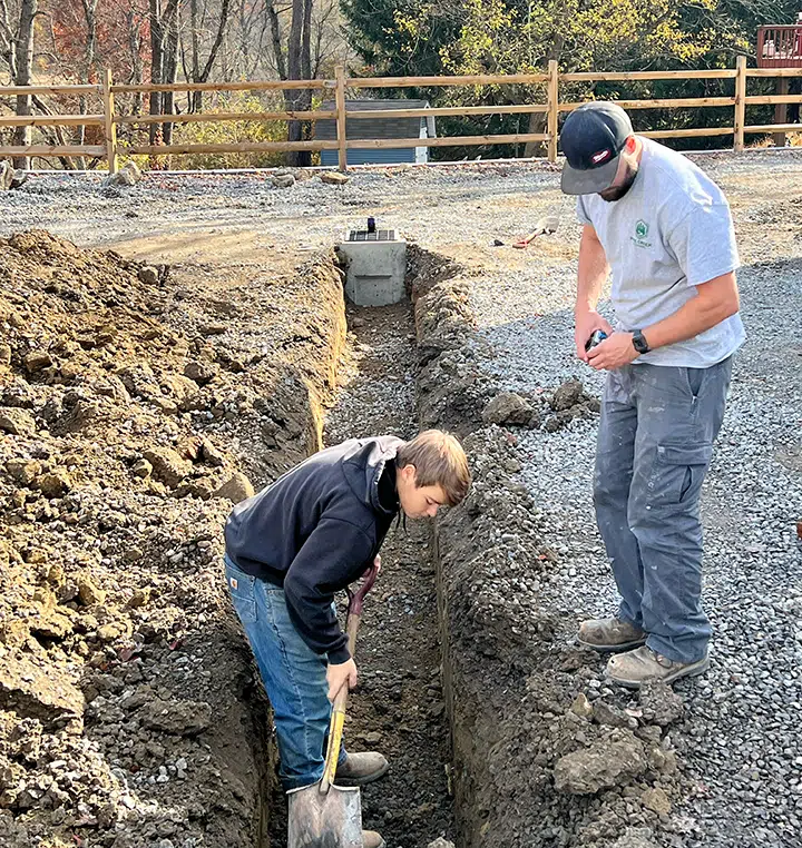 Technicians working on area drain installation in Wexford