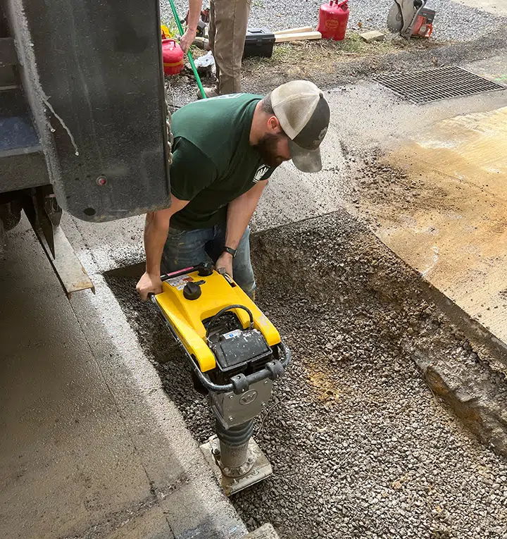 Technician performing backfill after trap sewer replacement in Wexford.