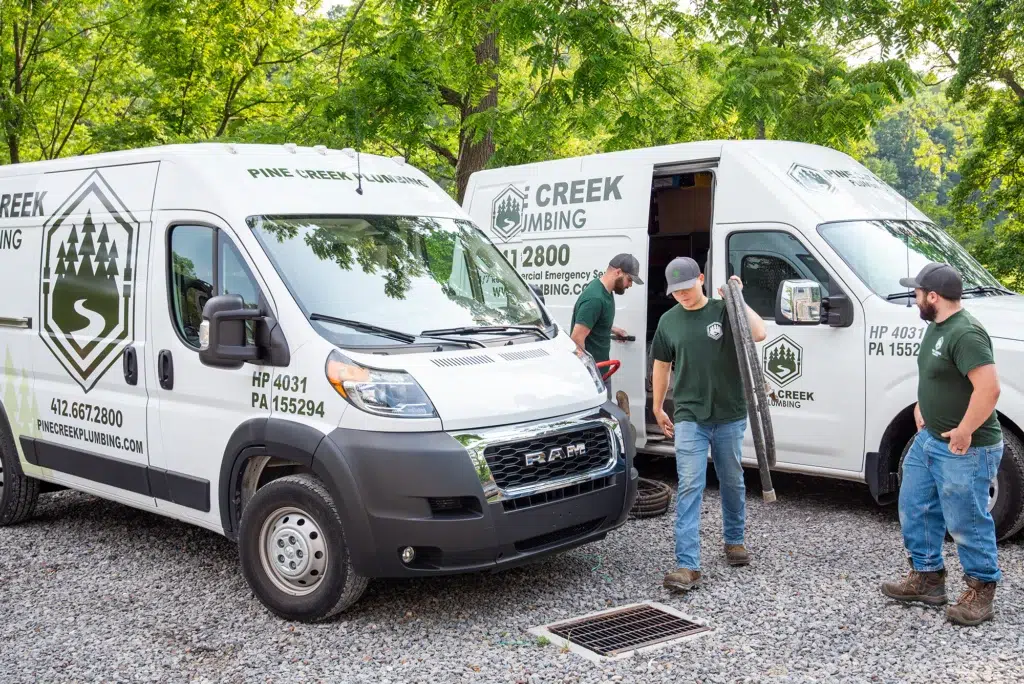 Technicians grabbing piping out of Pine Creek Plumbing truck in Wexford.