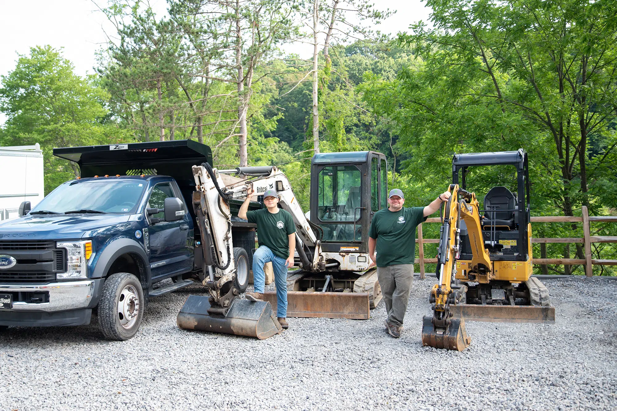 Pine Creek Plumbing technicians standing in front of excavators in Wexford.